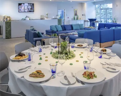 Elegant dining table and blue lounge in event space | The Cambridge Club | Social Club of Aberdeen, NJ 07747