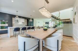 Open concept minimalist living room with plaster fireplace, neutral tones, and seamless floor layout in modern European interior design style.