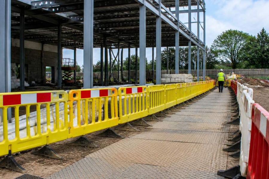 Building site with structural framework and safety barriers prepared for a building control site inspection.