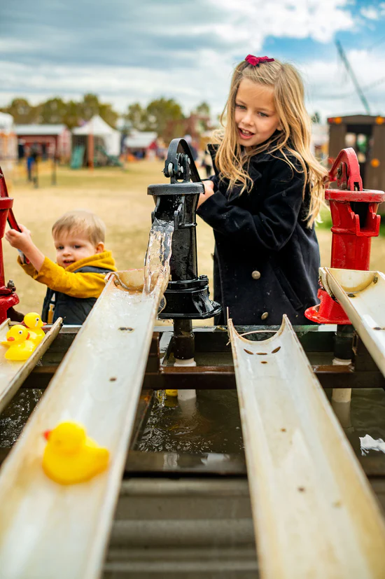 A girl having fun at the duck race activity.