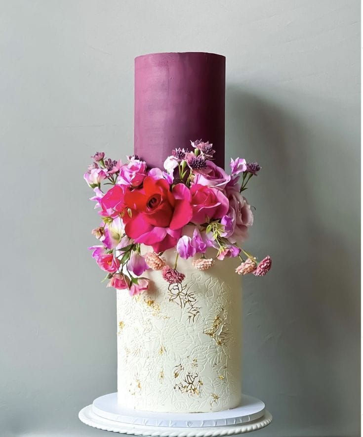 TWO TIERED PURPLE AND WHITE WEDDING CAKE WITH PINK AND PURPLE FLOWERS