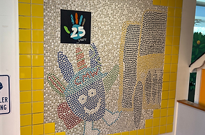 A photo of the mural created during the Museum's 25th Birthday Celebration, located by the front desk