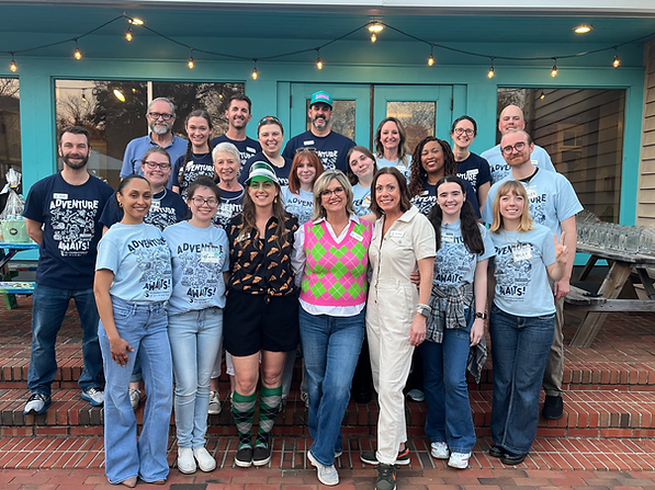 Staff members and volunteers gather for a photo before Pizza Putt 2025