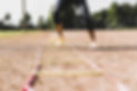 young-woman-exercising-on-sports-field-with-agility-ladder-681902083-38c6186ccea047ad8a054