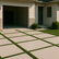 Modern Winter Park home with a polyaspartic-coated driveway of concrete squares separated by fine turf, showcasing premium exterior coatings by Revelry Coatings.
