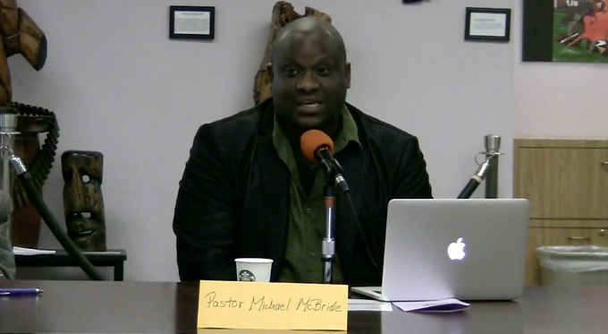 Pastor Michael McBride speaks at a town hall meeting at the Allen Temple Baptist Church