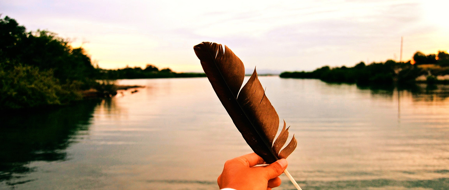 person holding black feather_edited_edit
