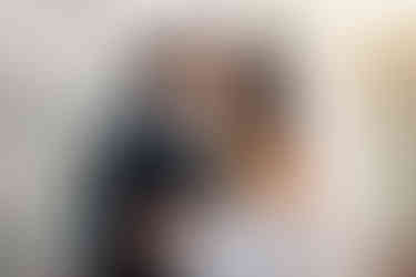 Bride and groom touch foreheads beside the tiled reflecting pool at Sherman Library and Gardens.