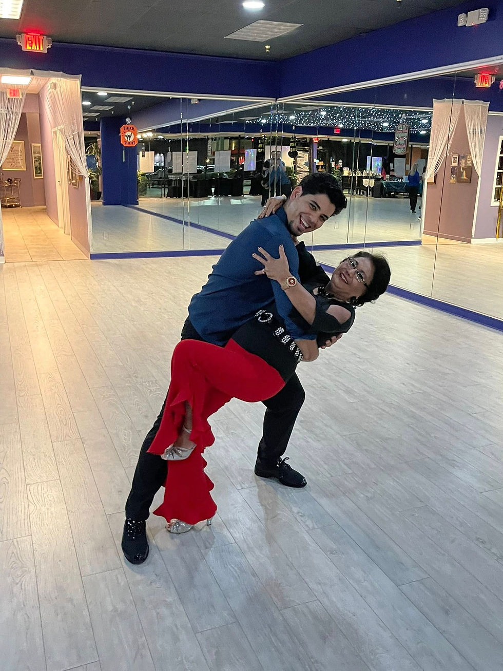 Couple practicing wedding dance lessons at home with instructor in Sarasota Florida