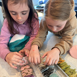 Two girls picking patches for their DIY Hat Bar with Three Sisters Patch Bar