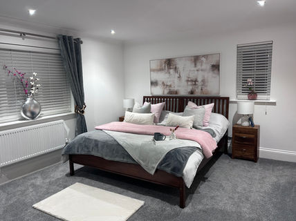 grey bedroom with pink tones