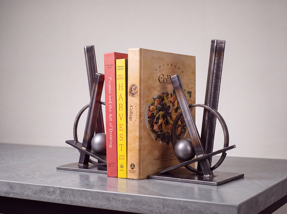 Angled view of DUALIS stainless steel bookends holding books on a tabletop