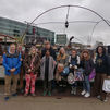 A group of people standing outside Word on the Water Book Barge on the Regent's Canal in London