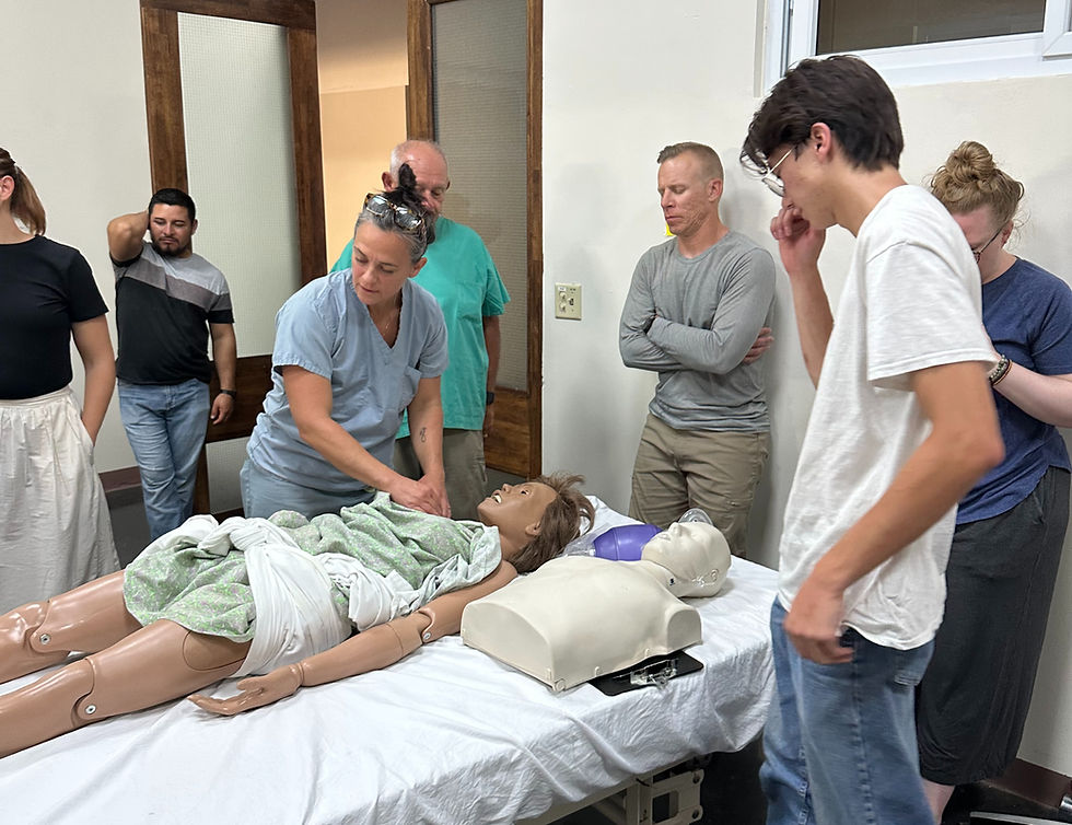 Bryn Kroto instructs others in proper CPR.