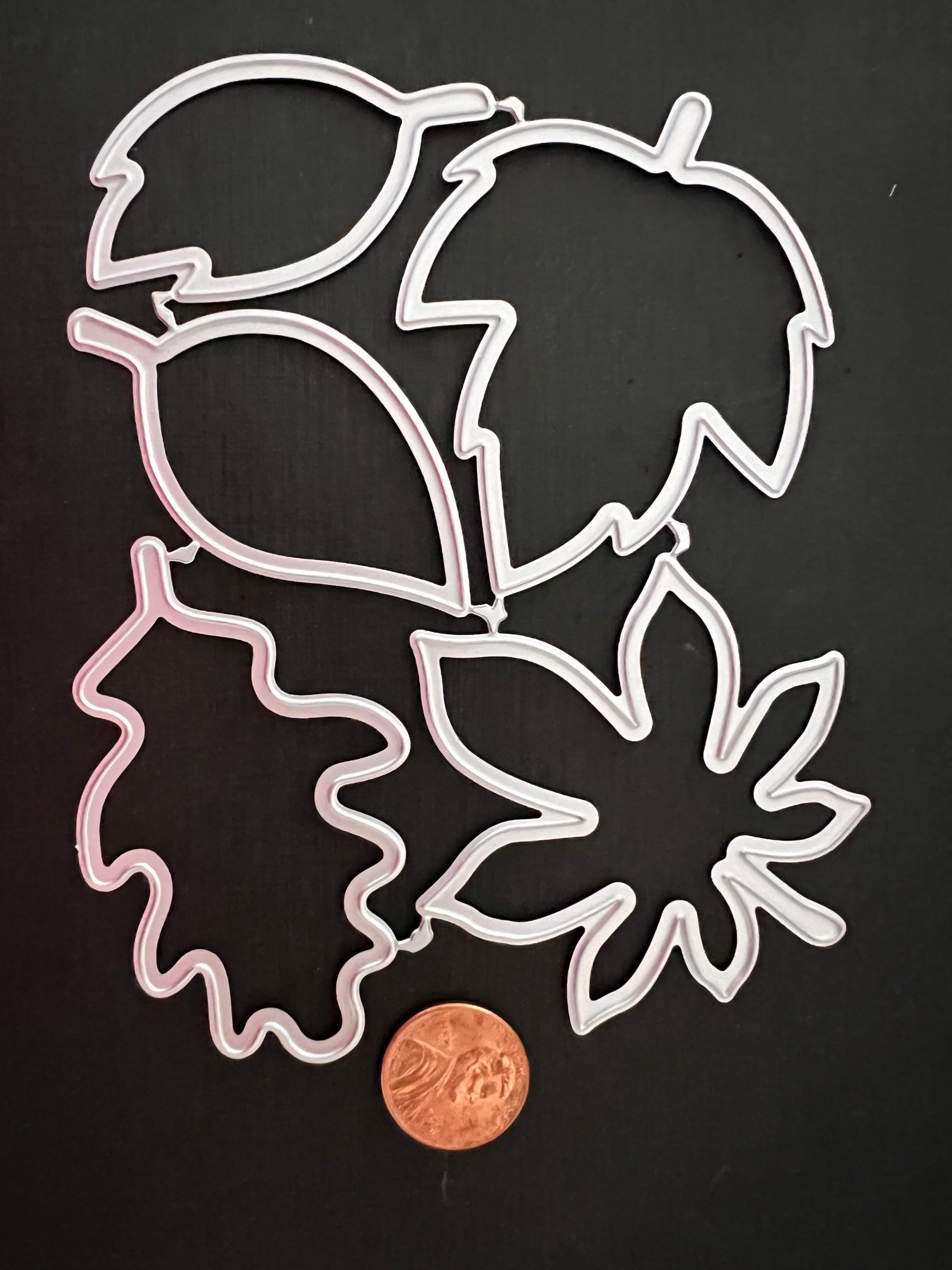 Thin metal leaf die cuts for shrink plastic.