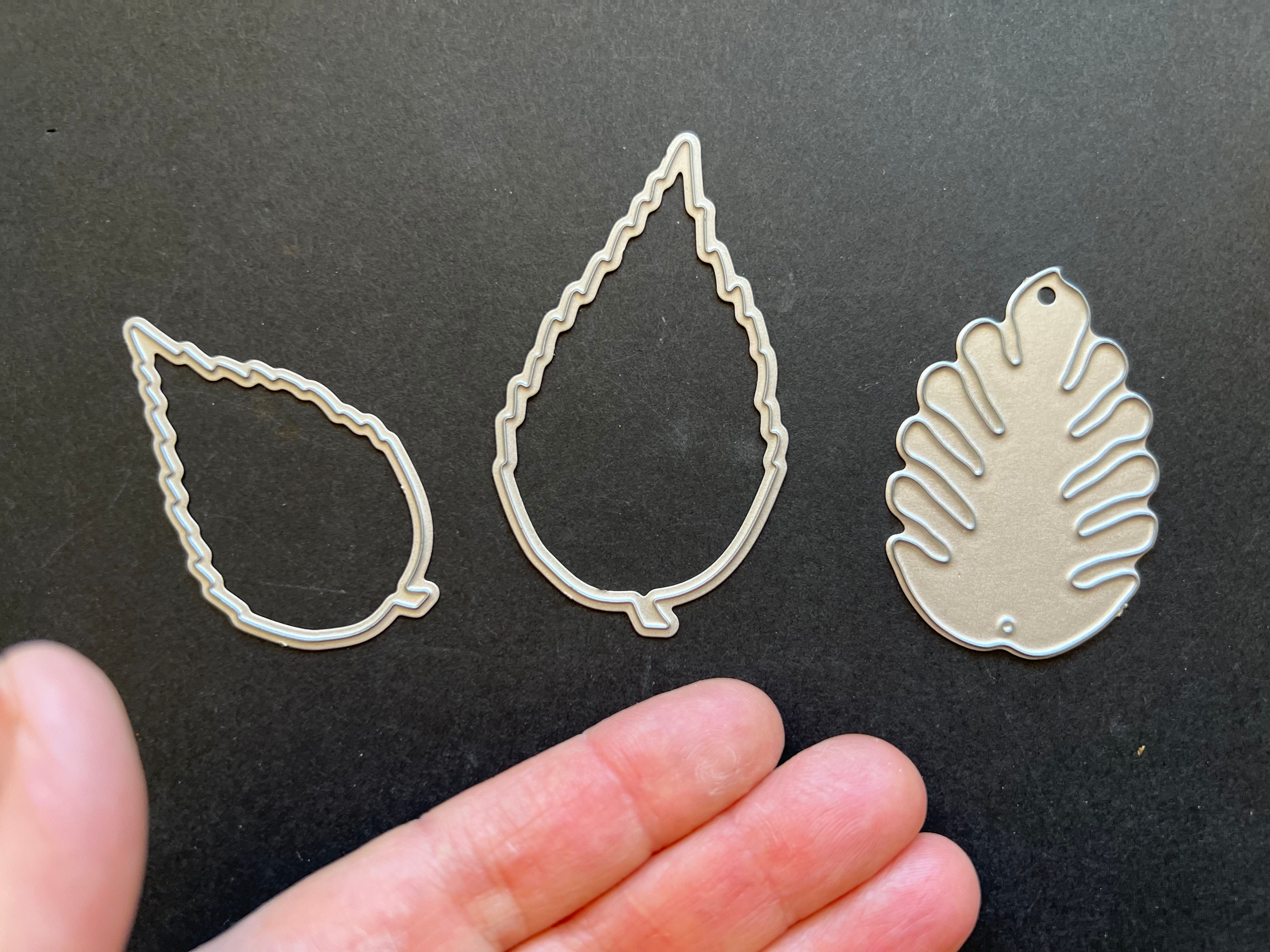 Thin metal die cuts leaf shapes.