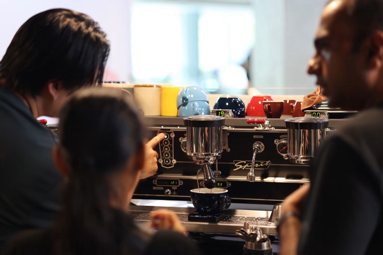 Natt and students exploring the controls of a Spirit espresso machine
