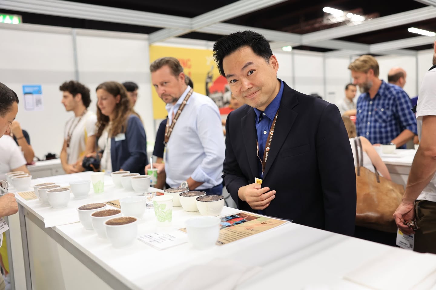 Coffee professionals tasting at a cupping table in the original academy post.