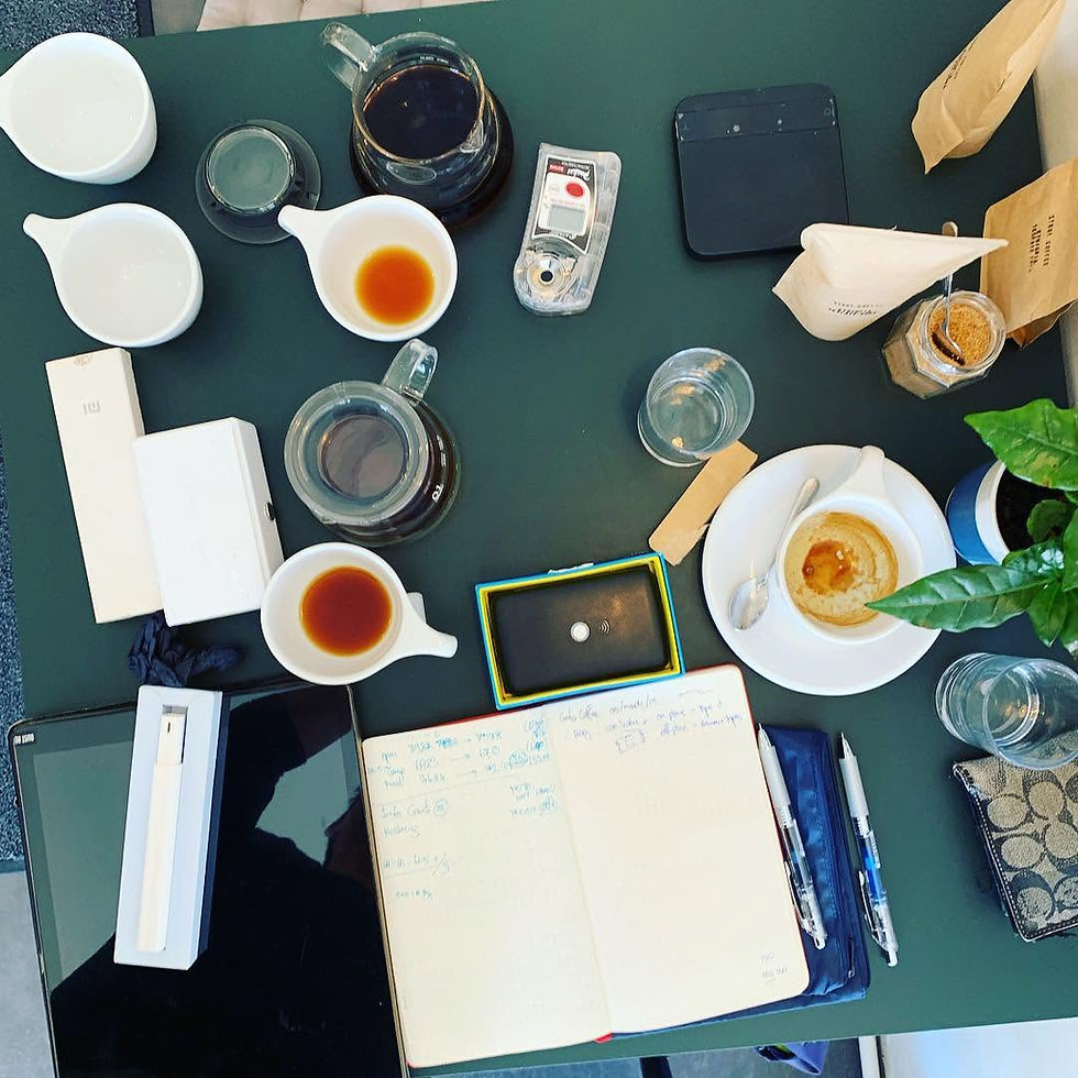 Cups, glass servers and brewing equipment on a table at Gota Coffee in Vienna.