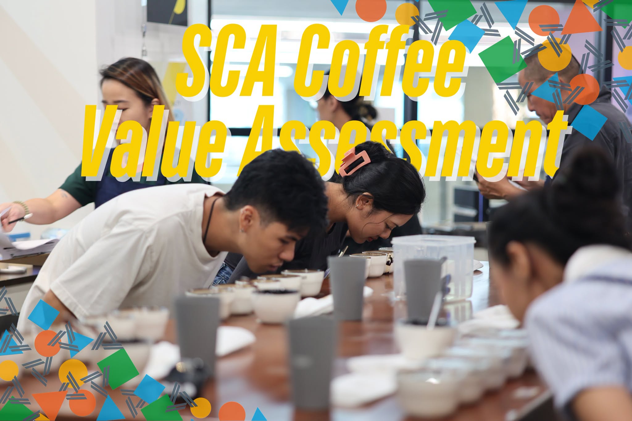 Students smelling coffee during CVA for Cuppers training in Bangkok, beneath the original SCA Coffee Value Assessment title.