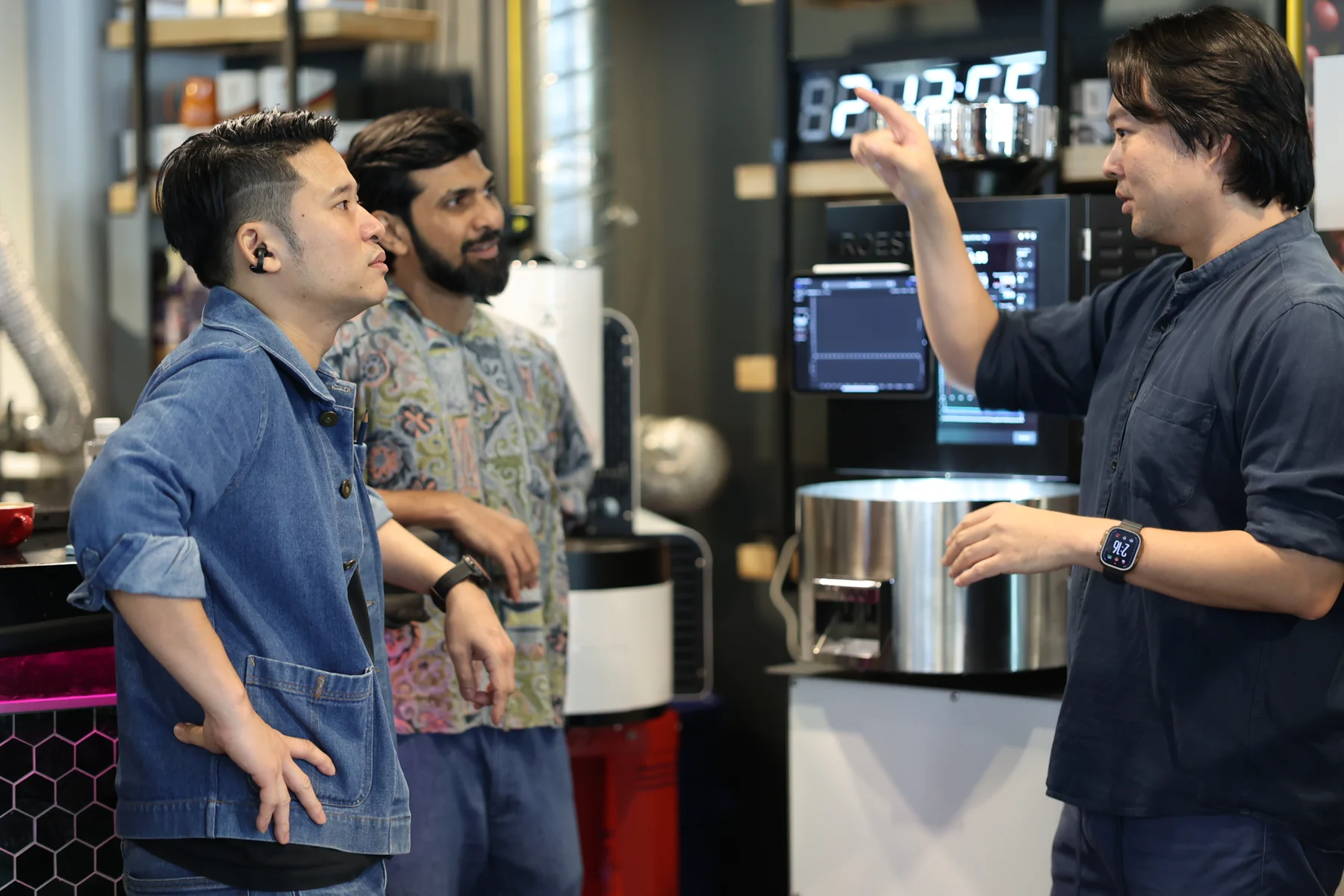 Natt discussing roasting with two students beside the ROEST at Espresso Academic.
