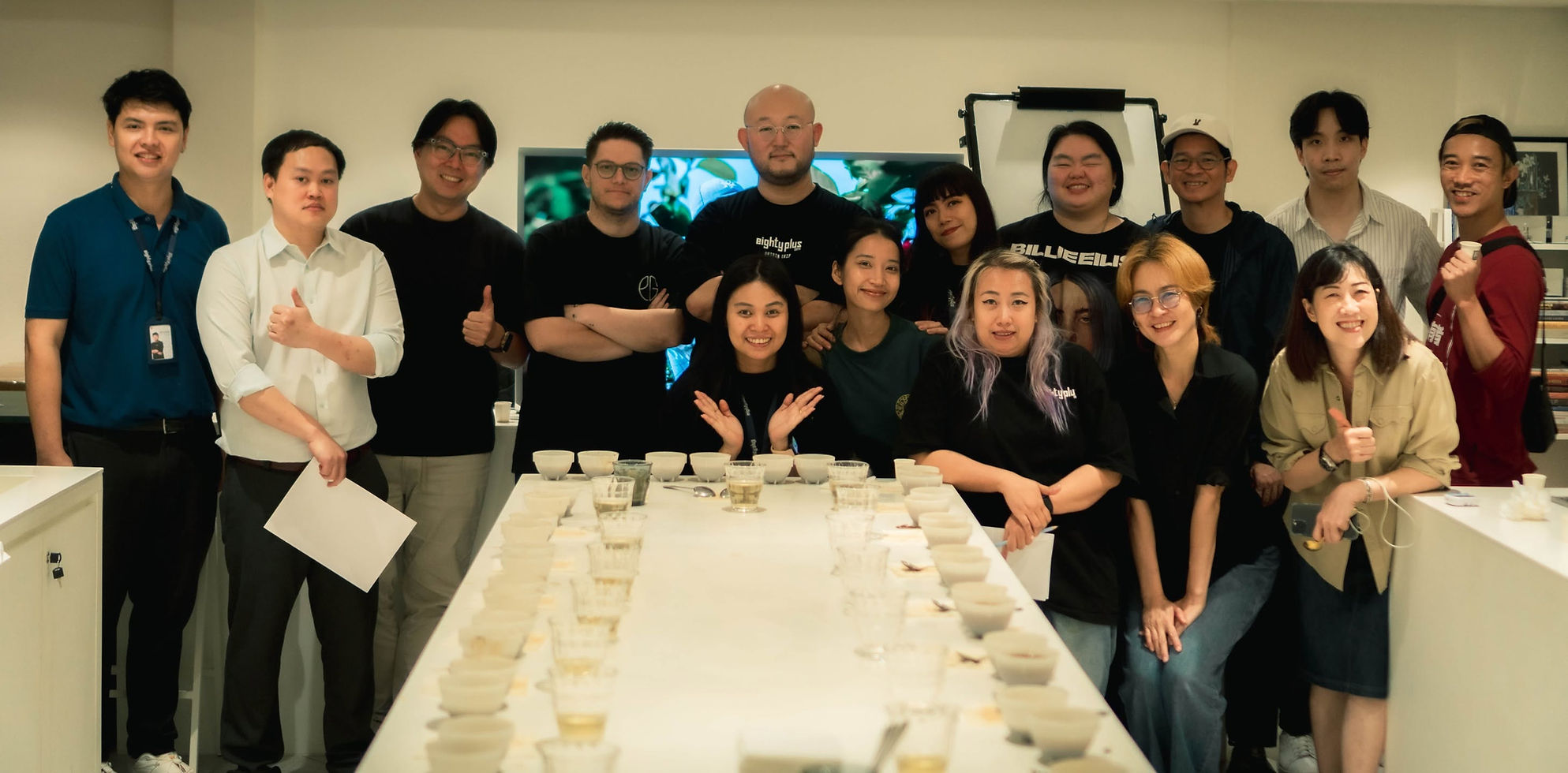 Coffee community members gathered around the cupping table at the Eighty Plus and PAGA Geisha-only session in Bangkok.