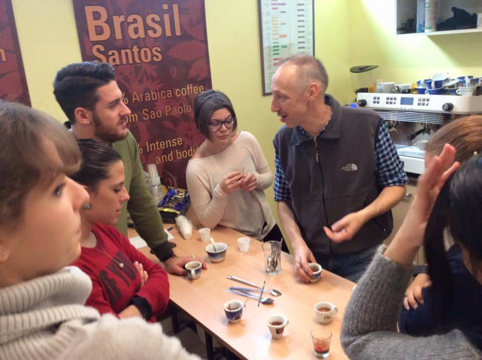 Participants gathered around cups of espresso during an Espresso Academy open-day practice session in Florence.