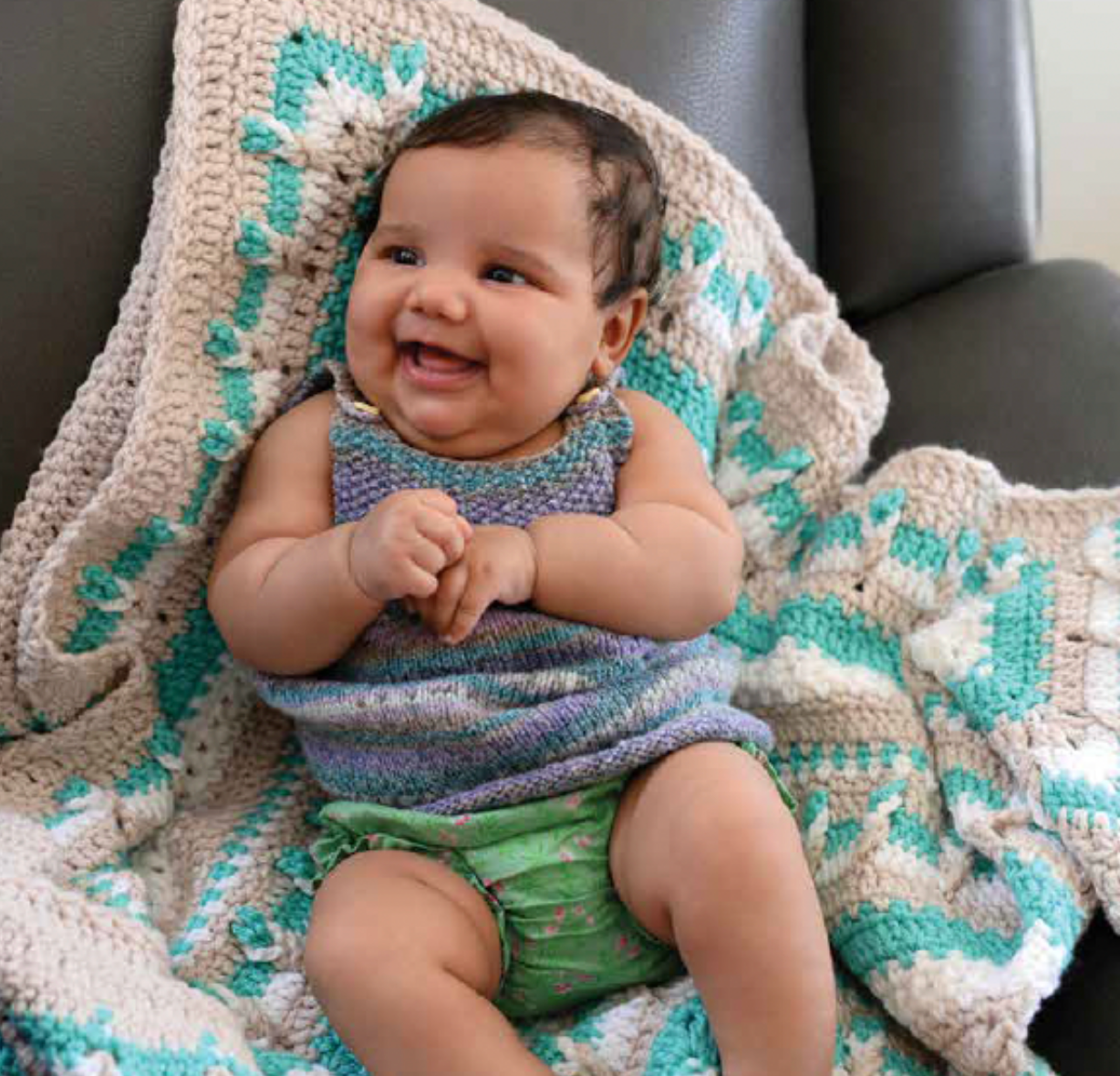 Baby laying on crochet blanket