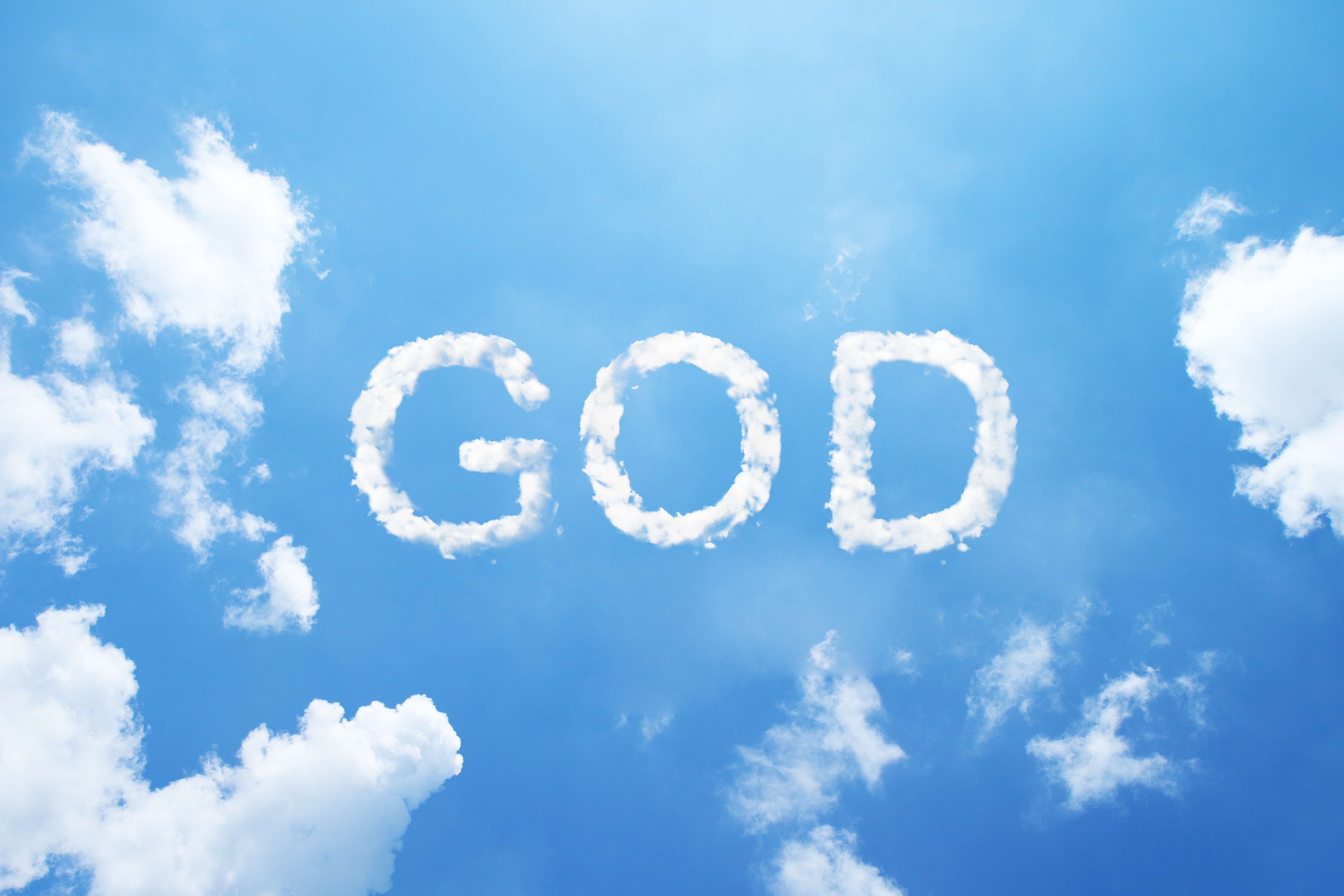 Clouds word as _GOD_ in capital letters on blue sky