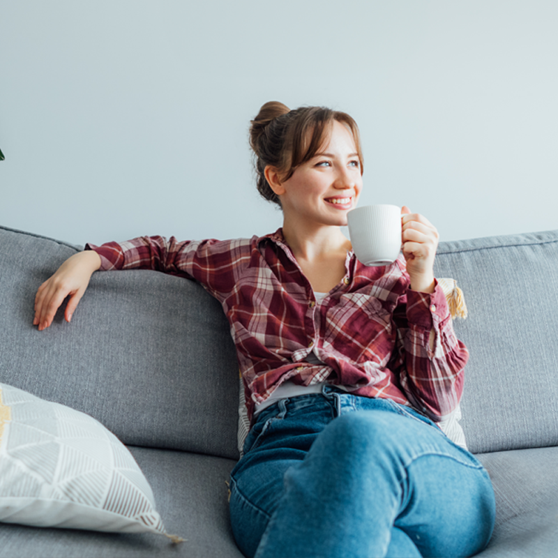 Woman smiling on clean couch
