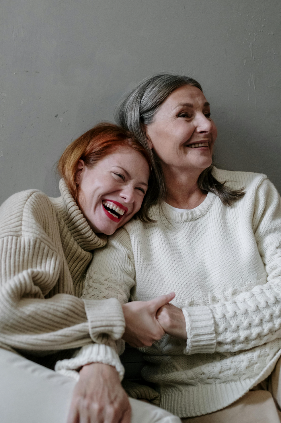 Mother and adult daughter laughing