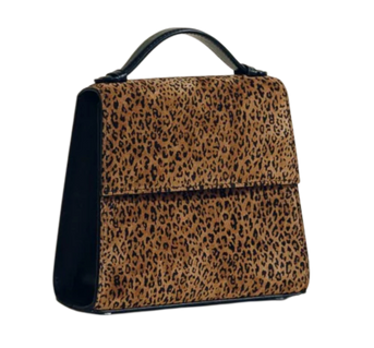 Cheetah print purse handcrafted in Spain with rounded handle, concealed magnetic closure, and an adjustable strap that give the option to wear as a crossbody.