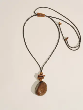 Hand-carved from sustainably sourced tagua seeds, this pendant brings together natural texture and refined simplicity. Natural variations in color and shape make each piece one of a kind.