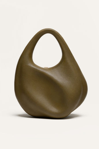 Crafted in limited editions by family-owned atelier outside Florence, the Fourier is a hard-construction top handle shaped through biomimicry. It opens with a push-button clasp, revealing a custom-engineered gold frame set within.