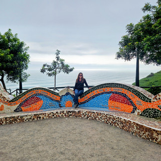Meredith Peters visiting Parque del Amor in Lima Peru beside the colorful mosaic mural