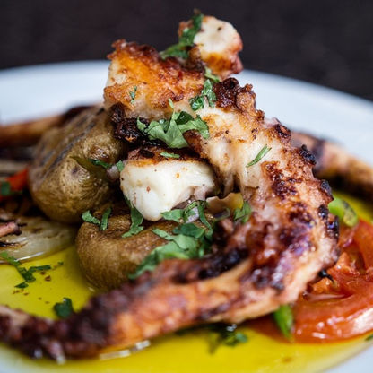Traditional Portuguese octopus dish with olive oil, vegetables, and herbs