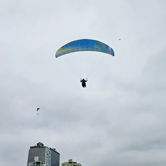Paraglider soaring above the Miraflores cliffs along the Lima Peru coastline