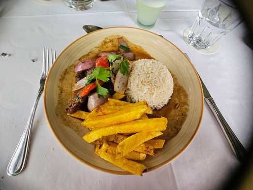 Traditional Peruvian beef dish served with onions, peppers, and rice in Lima Peru.