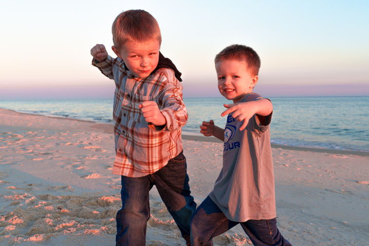 Two brothers pose in a boxing stance for their sunset portrait on St. George Island