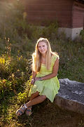 Senior girl (Nichols family) posing on a rock in a field