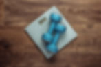two weights on a scale on hardwood floor