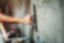 closeup hand of worker plastering cement