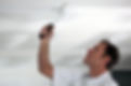 Man painting his ceiling white.jpg