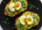 Healthy workplace catering avocado toast topped with sliced egg