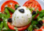 Caprese salad with tomato, mozzarella, and olives