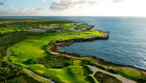 Natural beauty of La Cana Golf Course with lush greens and Caribbean Sea backdrop