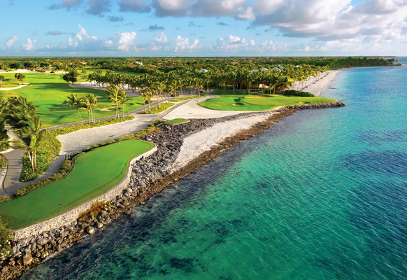 View of La Cana Golf Course featuring large mounds, devilish bunkers, and holes along the Caribbean Sea shoreline