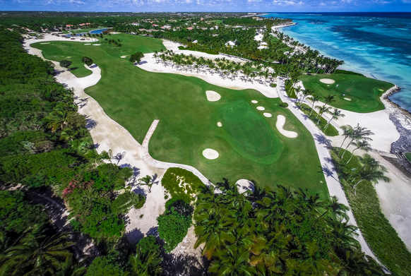 Scenic landscape of La Cana Golf Course with diverse terrain and ocean views from multiple holes