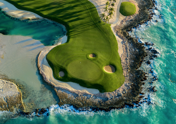 Scenic Punta Espada Golf Course surrounded by vibrant shades of blue in the Caribbean Sea