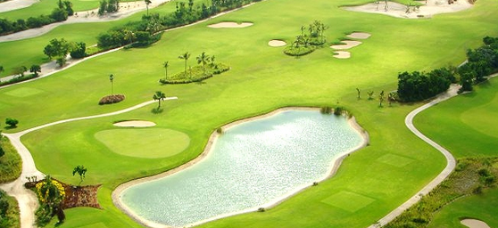 Sunlit golf course bordered by dense Dominican greenery at Punta Blanca